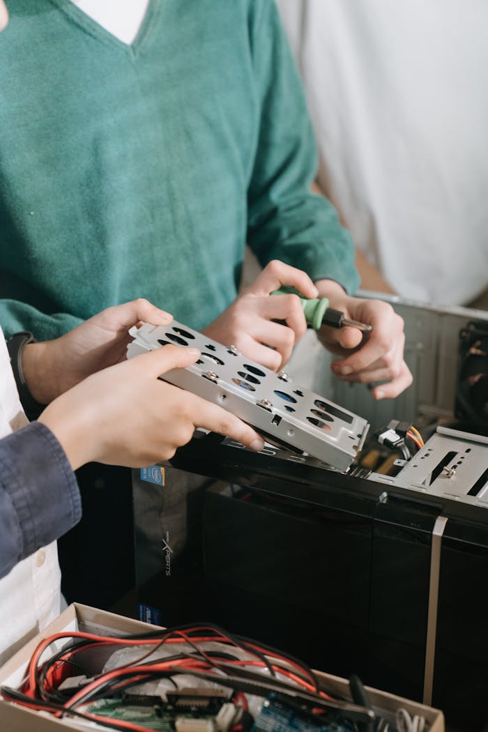 Mastering the First Impression: Your intriguing post title goes here Close-up of technicians repairing computer hardware with tools, focusing on hands and equipment.